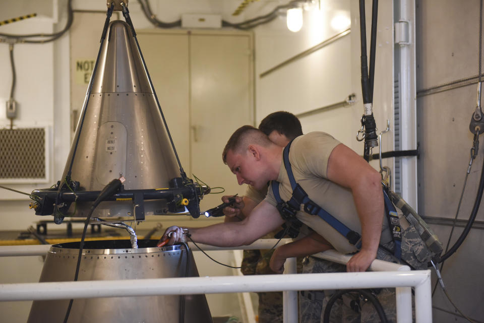 In this image provided by the U.S. Air Force, Senior Airmen Andrew Whitener and Tyler Glodgett 341st Missile Maintenance Squadron topsiders, inspect the cable connections of an intercontinental ballistic missile during a Simulated Electronic Launch-Minuteman test Sept. 22, 2020, at a launch facility near Great Falls, Mont. The top Air Force officer in charge of the nation's air and ground-launched nuclear missiles has requested an official investigation into the number of officers who are reporting the same type of blood cancer after serving at Malmstrom Air Force Base. (Tristan Day/U.S. Air Force via AP)