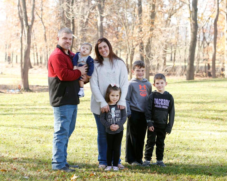 The Detwiler family Brad, left, holding 19-month-old David, Carlla, Stella, 4, Domenik, 7, and Daniel, 6, take a portrait in Massillon.