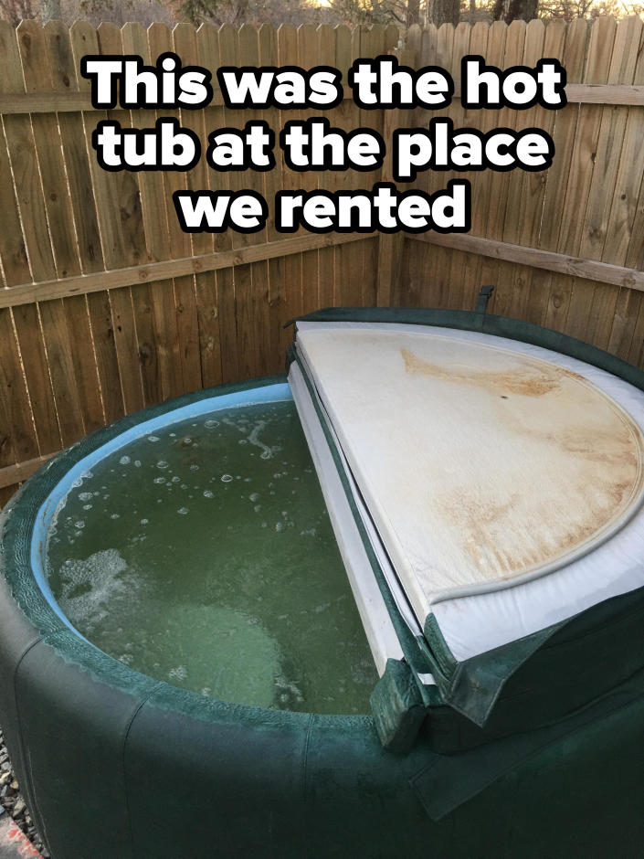 A hot tub with a stained cover and dank water with bubbles is at the place they rented