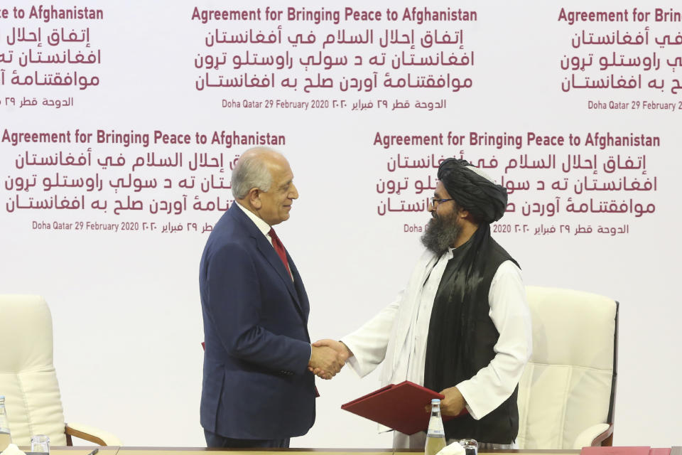 U.S. peace envoy Zalmay Khalilzad, left, and Mullah Abdul Ghani Baradar, the Taliban group's top political leader shake hands after signing a peace agreement between Taliban and U.S. officials in Doha, Qatar on Feb. 29, 2020. (Hussein Sayed/AP)