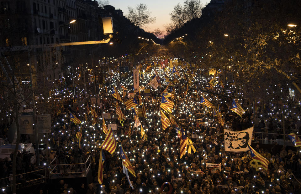 Pro independence demonstrators march waving esteladas or independece flags, during a demonstration supporting the imprisoned pro-indenpence political leaders in Barcelona, Spain, Saturday, Feb. 16, 2019. Hundred of thousands of Catalan separatists are marching in Barcelona to proclaim the innocence of 12 of their leaders who are on trial for their role in a failed 2017 secession bid. (AP Photo/Emilio Morenatti)