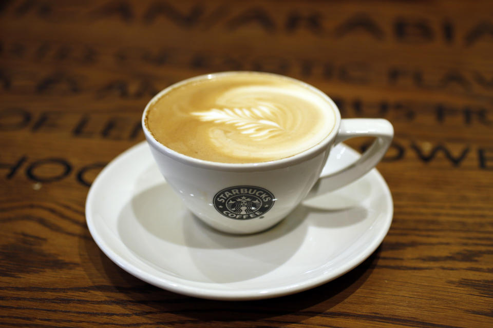 A cup of coffee sits on a table in Starbucks' Vigo Street branch in Mayfair, central London January 11, 2013.  REUTERS/Stefan Wermuth (BRITAIN - Tags: BUSINESS LOGO FOOD)