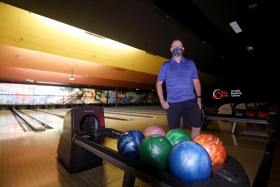 Jim Monahan poses among the empty lanes at All Star Lanes & Casino in Silverdale, Wash.