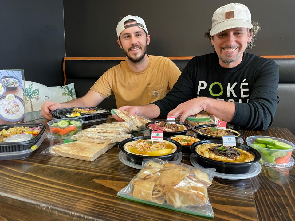 From left, Hummus Hut managing partner Taylor Daher and founder Chris Bachuwa present a sampling of hummus and other Middle Eastern-inspired dishes to reporters from The Daily for a taste test, Thursday, Nov. 30, 2023.