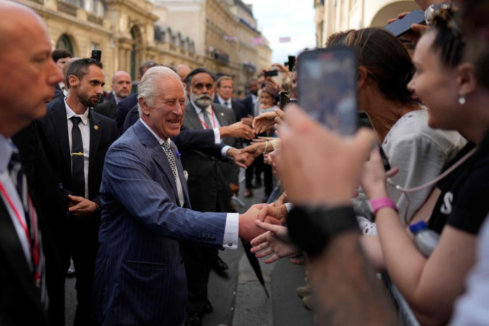 Britain's King Charles III greets well-wishers on the streets of Paris during a state visit. The King and Queen Camilla met with President Emmanuel Macron.