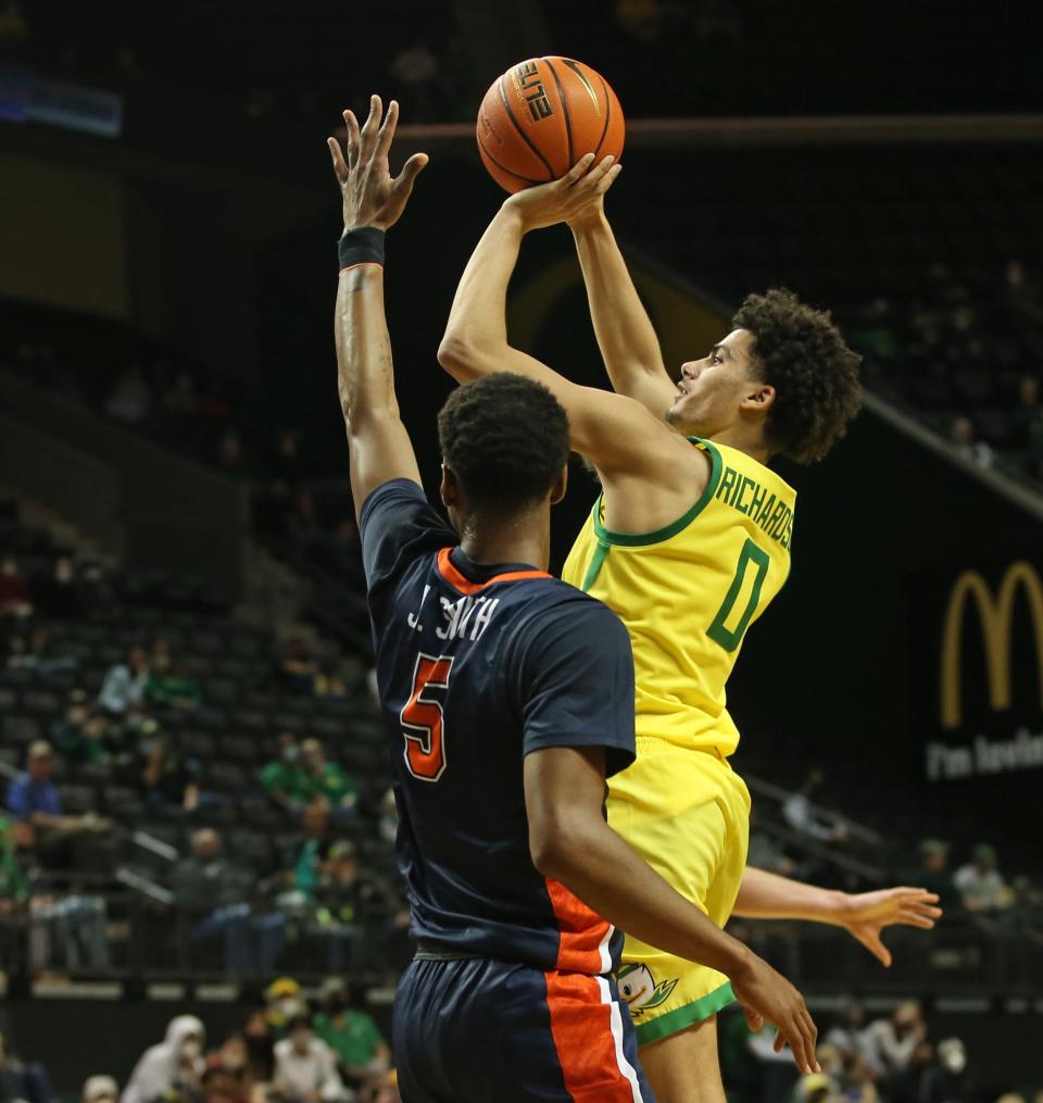 Oregon's Will Richardson, right, goes up for a shot against Pepperdine's Jade Smith during the second half of their game in December.