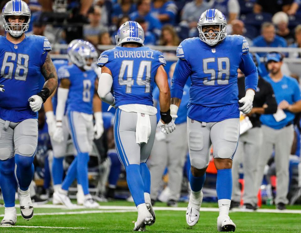 Sep 18, 2022; Detroit, Michigan, USA; Detroit Lions offensive tackle Penei Sewell (58) shakes hands with linebacker Malcolm Rodriguez (44) as he takes the field for offensive play against the Washington Commanders during the second half at Ford Field.