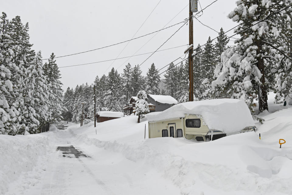 A camper is buried in snow in a Donner Lake neighborhood on Friday, March 4, 2024, in Truckee, Calif. A powerful blizzard that closed highways and ski resorts had moved through the Sierra Nevada by early Monday, but forecasters warned that more snow was on the way for the Northern California mountains. More than 7 feet (2.1 meters) of snow fell in some locations and fierce winds lashed the Sierra over the weekend. (AP Photo/Andy Barron)