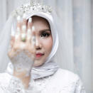 A wedding photo of the bride of a Lion Air flight JT610 victim, who carried on the celebration despite the absence of the groom, in Bangka, Bangka Belitong Province, Indonesia November 11, 2018 in this picture obtained from social media on November 16, 2018. LALA INDRA PERMANA/via REUTERS