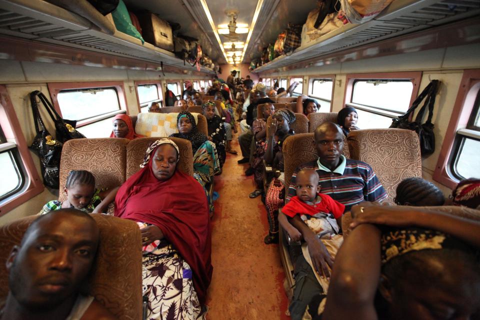 In this Photo taken, Friday, March . 8, 2013, Passengers ride a board an Ooni of Ife train to Kano, Nigeria. Nigeria reopened its train line to the north Dec. 21, marking the end of a $166 million project to rebuild portions of the abandoned line washed out years earlier. The state-owned China Civil Engineering Construction Corp. rebuilt the southern portion of the line, while a Nigerian company handled the rest. The rebirth of the lines constitutes a major economic relief to the poor who want to travel in a country where most earn less than $1 a day. Airline tickets remain out of the reach of many and journeys over the nation's crumbling road network can be dangerous. The cheapest train ticket available costs only $13. ( AP Photo/Sunday Alamba)