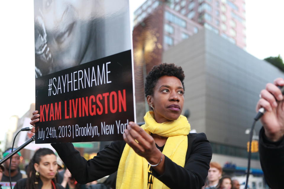 Social justice leader, writer, and artist Piper Anderson holding Kyam Livingston's placard. 