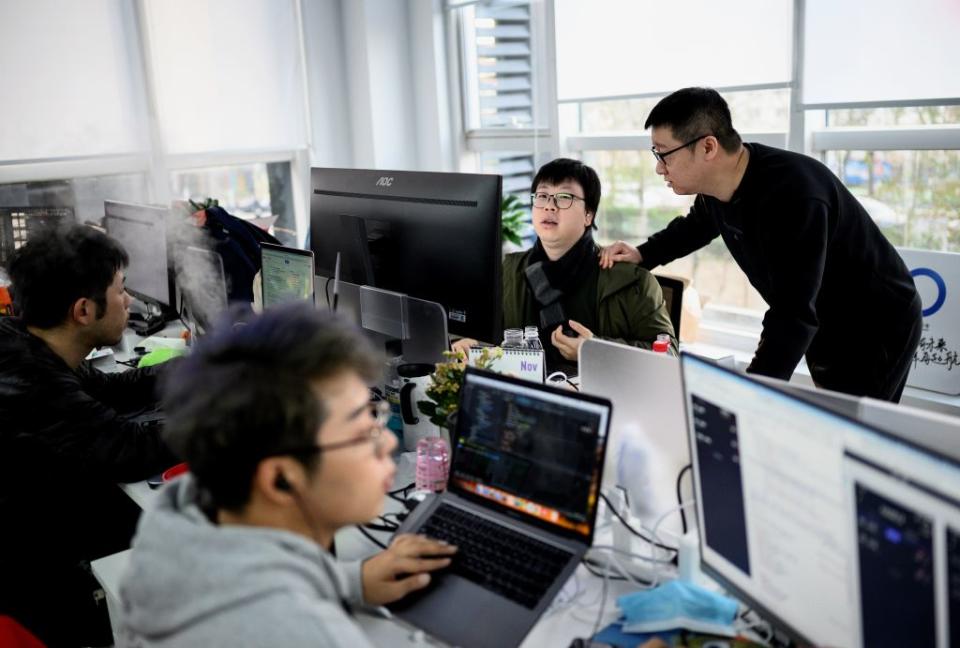 This picture taken on December 10, 2020 shows BlueCity CEO, Ma Baoli (R), talking to an employee at the BlueCity headquarters in Beijing. -<span class="copyright">NOEL CELIS/AFP via Getty Images</span>
