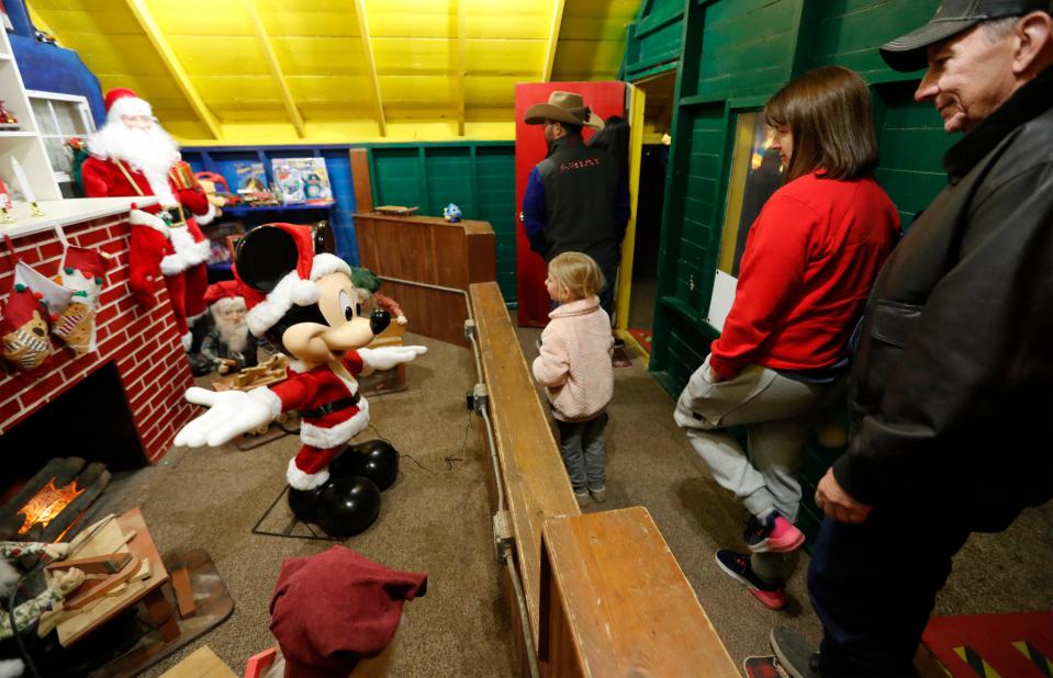 Visitors walk through Santa’s Workshop featuring Mickey Mouse. Parents and their families attended Santa Land Sunday night marking the 67th year that the attraction has been in operation. The annual event was hosted by the Lubbock Parks and Recreation Department and will be in operation through Thursday, Dec. 21.