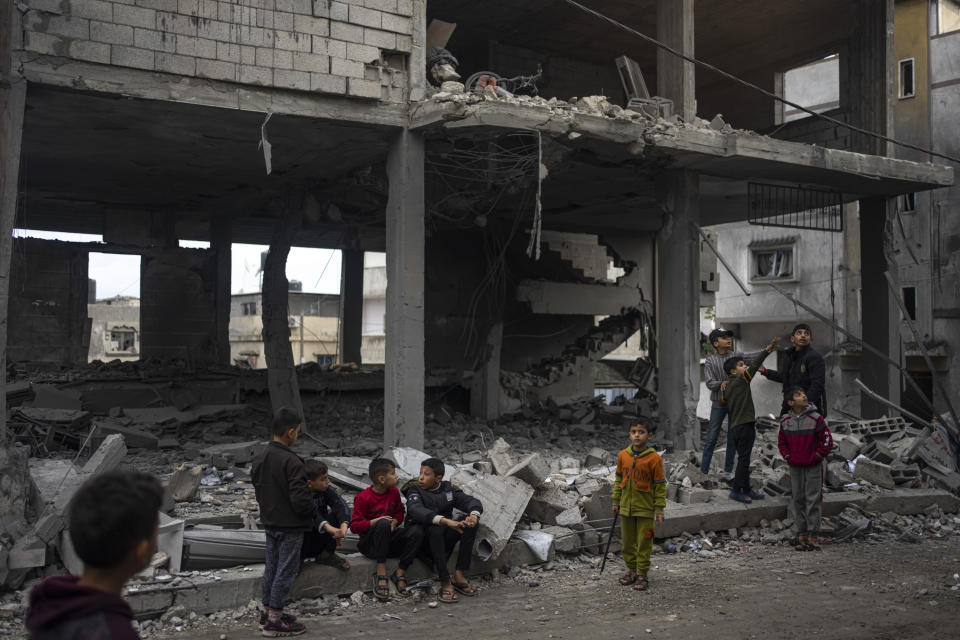 Palestinians look at the destruction after an Israeli strike in Rafah, southern Gaza Strip, Wednesday, Jan. 3, 2024. (AP Photo/Fatima Shbair)