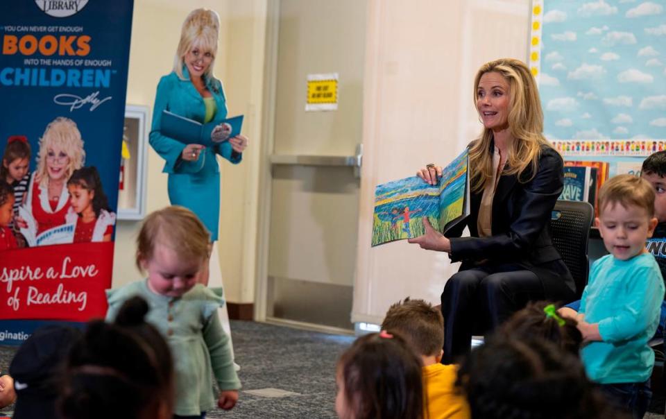 First Partner Jennifer Siebel Newsom reads a bilingual storybook to children Tuesday at the Arthur F. Turner Community Library in West Sacramento during an event announcing that Dolly Parton’s Imagination Library program, which provides free monthly books to children under age 5, would begin its statewide expansion.