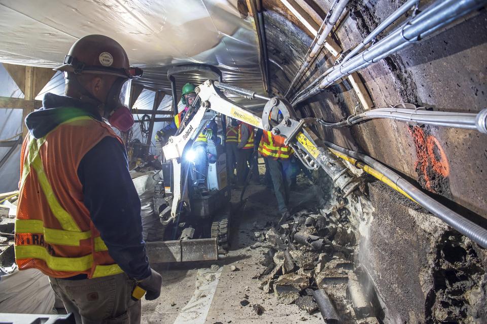 This May 19, 2019 photo provided by the Metropolitan Transportation Authority shows workers during the L Project subway tunnel rehabilitation, in New York. Eight years ago Thursday, Oct. 29, 2020, Superstorm Sandy pushed the Hudson River over its banks, sending 8 feet of water onto underground tracks and leaving the main waiting room unusable for months. New York's Metropolitan Transportation Authority, which serves several million riders daily on subways, trains and buses, had to repair damage to more than a dozen bridges and tunnels, many pre-dating World War II, caused by tens of millions of gallons of saltwater. (Trent Reeves/Metropolitan Transportation Authority via AP)