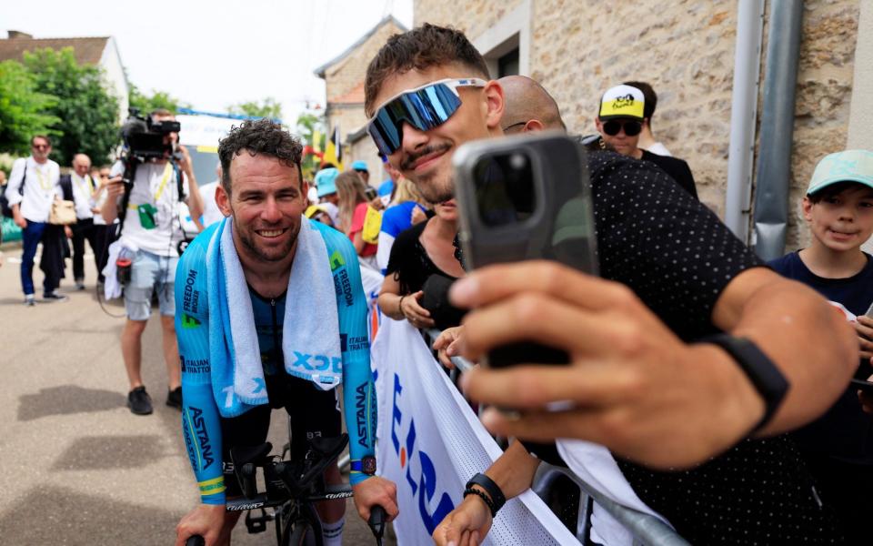 Mark Cavendish poses for a photo after the time trial