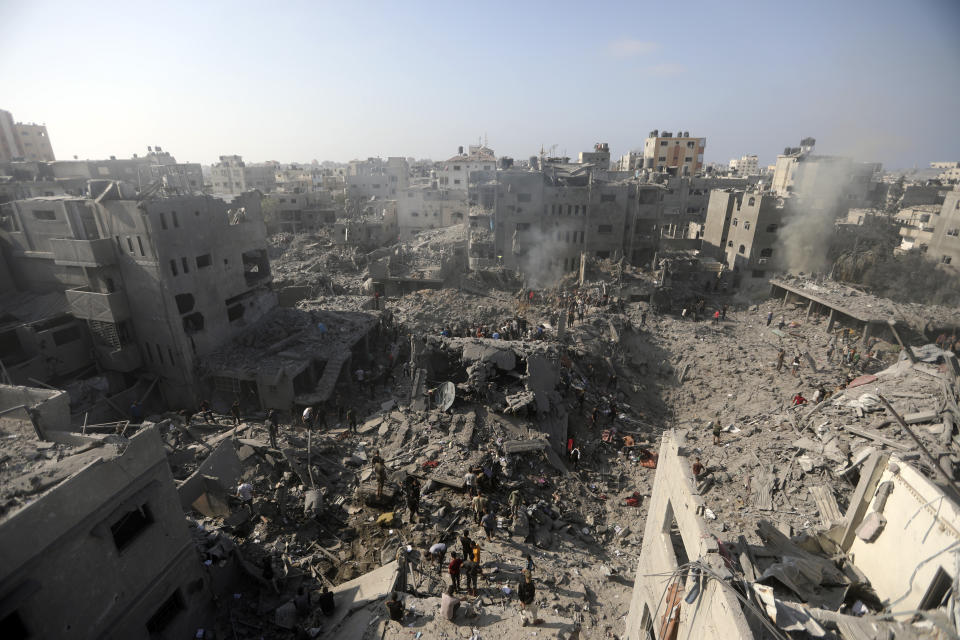 Palestinians look for survivors in the rubble of a destroyed building following an Israeli airstrike in Bureij refugee camp, Gaza Strip, Thursday, Nov. 2, 2023. (AP Photo/Mohammed Dahman)