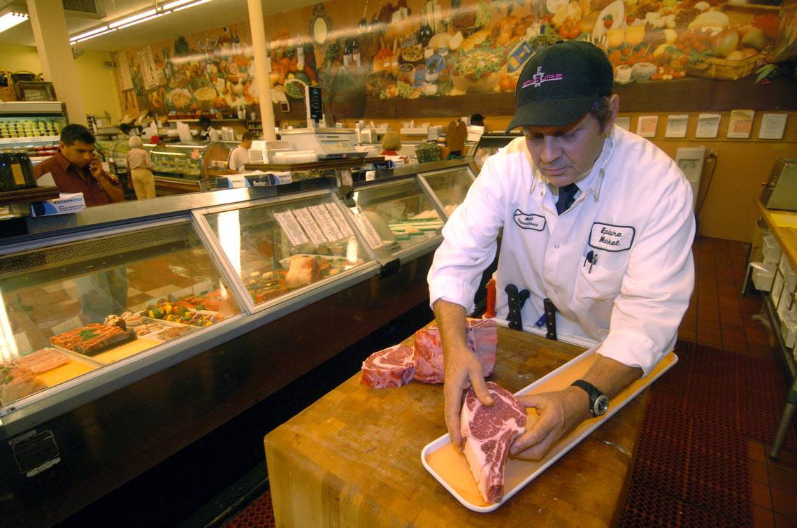 Rudiger Fersch, a butcher at Epicure, cuts a piece of beef on a butcher block for his customers. Peter Andrew Bosch/Miami Herald File / 2007