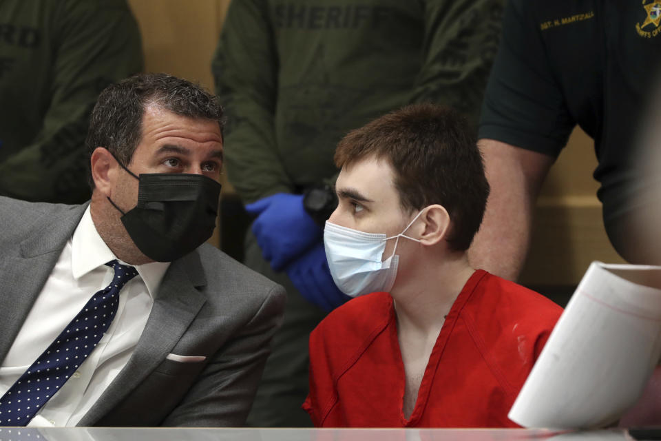 Parkland school shooter Nikolas Cruz speaks to defense attorney Gabe Ermine during a pre-trial hearing at the Broward County Courthouse in Fort Lauderdale, Fla., Wednesday, July 14, 2021, on four criminal counts stemming from his alleged attack on a Broward jail guard in November 2018. Cruz is accused of punching Sgt. Ray Beltran, wrestling him to the ground and taking his stun gun. (Amy Beth Bennett/South Florida Sun-Sentinel via AP, Pool)