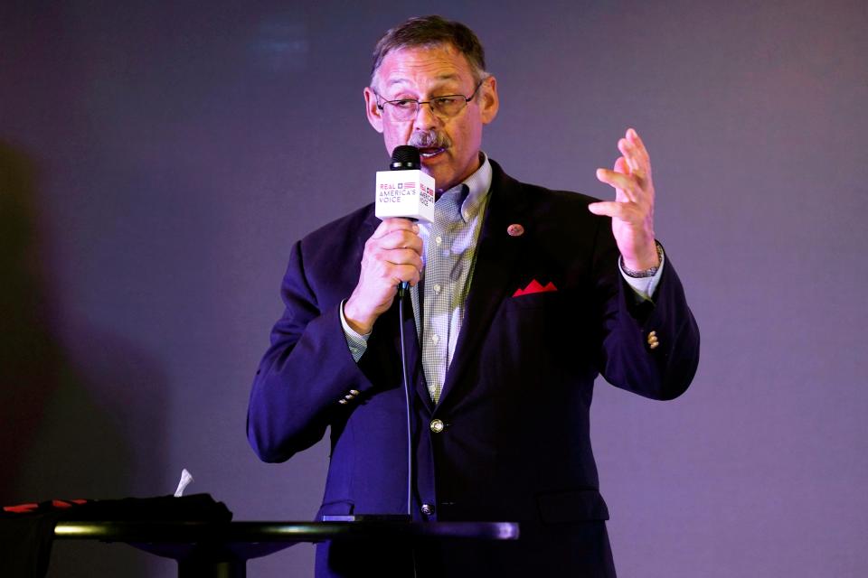 Rep. Mark Finchem, of Arizona, gestures as he speaks during an election rally in Richmond, Va., on Oct. 13, 2021.