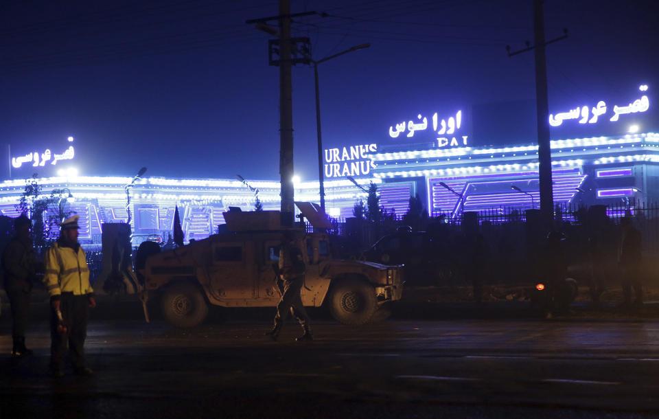 Security forces inspect the site of a suicide attack, happened inside a wedding hall in Kabul, Afghanistan, Nov. 20, 2018. Afghan officials said the suicide bomber targeted a gathering of Muslim religious scholars in Kabul, killing tens of people. A Public Health Ministry spokesman said another 60 people were wounded in the attack, which took place as Muslims around the world marked the birthday of the Prophet Mohammad. (AP Photo/Massoud Hossaini)