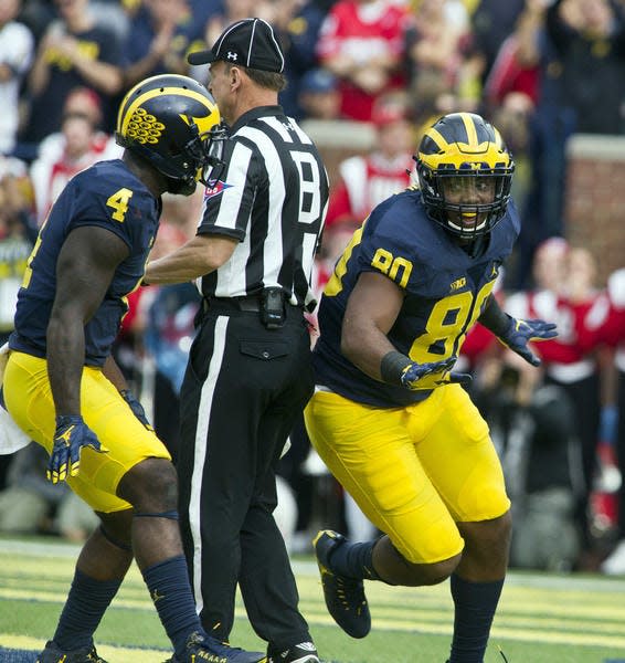 Michigan running back De'Veon Smith (4) celebrates with fullback Khalid Hill (80) after Hill scored against Wisconsin Oct. 1.AP Photo/TONY DING