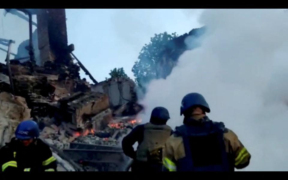 Emergency crew tend to a fire after a school was reportedly struck by Russian shelling (via REUTERS)