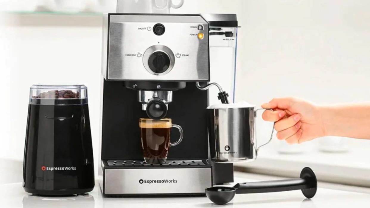  An Espresso Works All-In-One coffee machine in stainless steel making espresso. 