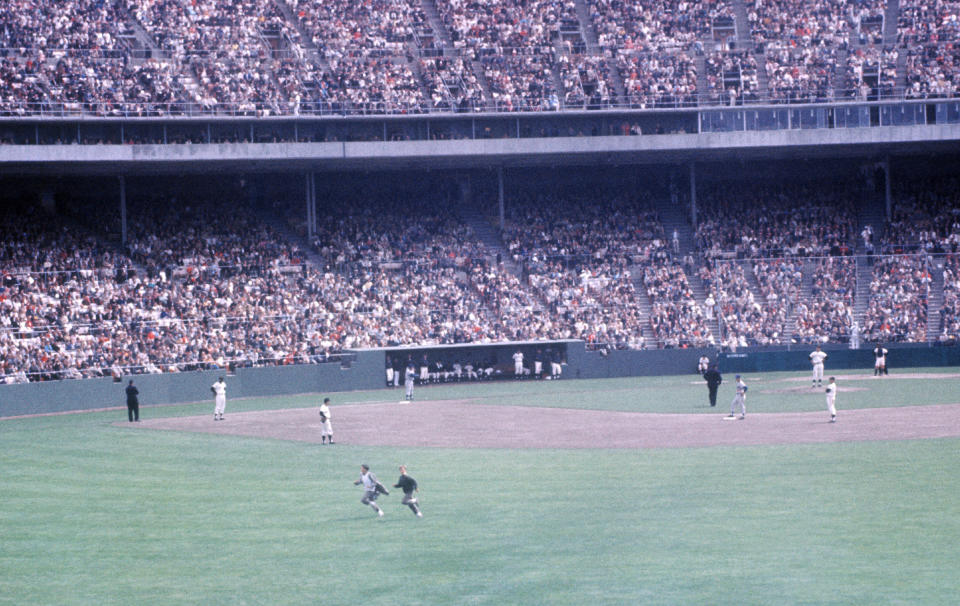 Two unruly fans run on the field during an MLB game between the Los Angeles Dodgers and San Francisco Giants on May 20, 1961 at Candlestick Park in San Francisco, California. (Photo by Hy Peskin/Getty Images) (Set Number: X7575)