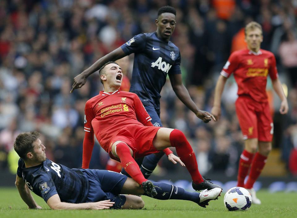 Liverpool's Aspas is challenged by Manchester United's Carrick during their English Premier League soccer match at Anfield, Liverpool