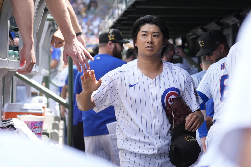Chicago Cubs pitcher Shota Imanaga is greeted in the dugout as he heads to the tunnel after pitching in the fifth inning of a baseball game against the Pittsburgh Pirates, Saturday, May 18, 2024, in Chicago. (AP Photo/Charles Rex Arbogast)