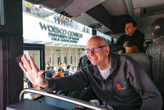 Miami Hurricanes men’s basketball head coach Jim Larrañaga waves to fans outside the University of Miami’s Watsco Center as the team prepares to depart on Wednesday, March 29, 2023, for the NCAA Final Four games in Houston.
