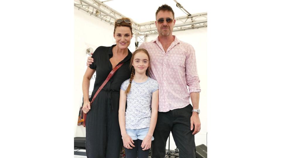 Sarah Parish standing with James Murray and their daughter Nell