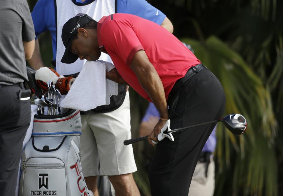 Tiger Woods wipes his face before teeing off on the 12th hole during the final round of the Cadillac Championship golf tournament Sunday, March 9, 2014, in Doral, Fla. (AP Photo/Lynne Sladky)