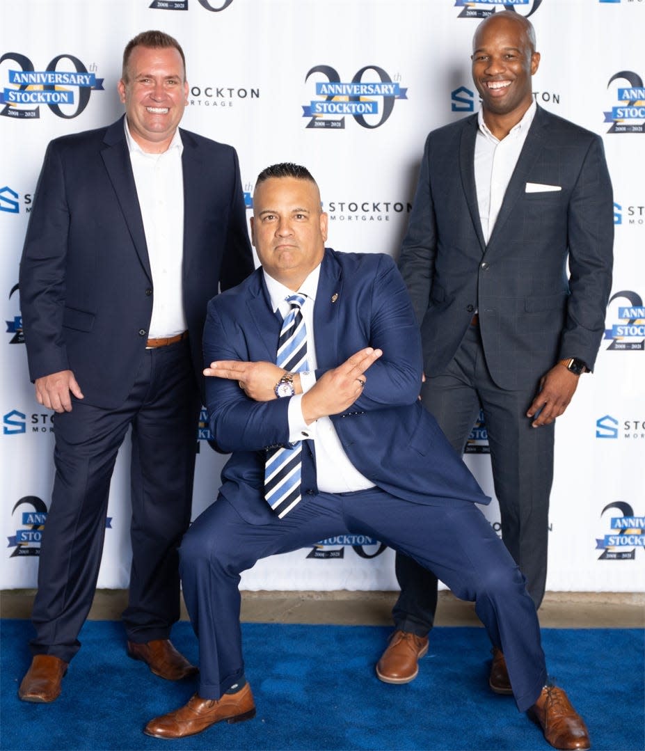 Stockton Mortgage executives Kris Vanzant, Jeff Ratanapool, and Anthony Whiteside, having fun on the blue carpet