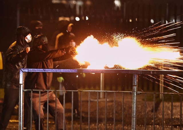 Youths discharge fireworks at the PSNI on the Springfield Road 