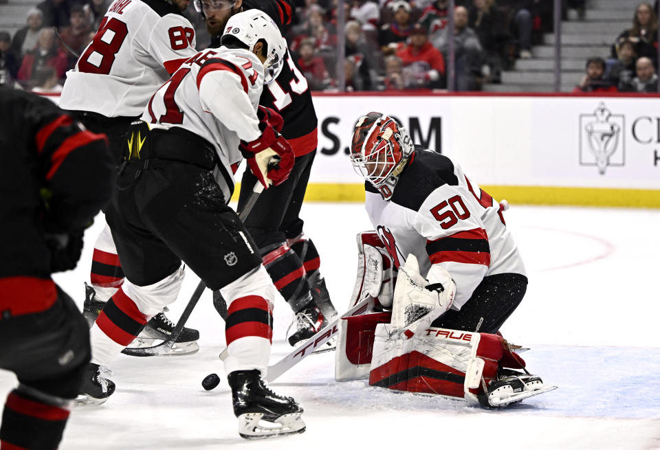 New Jersey Devils goaltender Nico Daws (50) makes a save against the Ottawa Senators during the second period of an NHL hockey game, Friday, Dec. 29, 2023 in Ottawa, Ontario. (Justin Tang/The Canadian Press via AP)