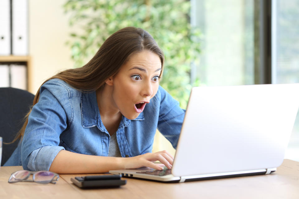 Amazed woman staring at computer. (Image: Getty)