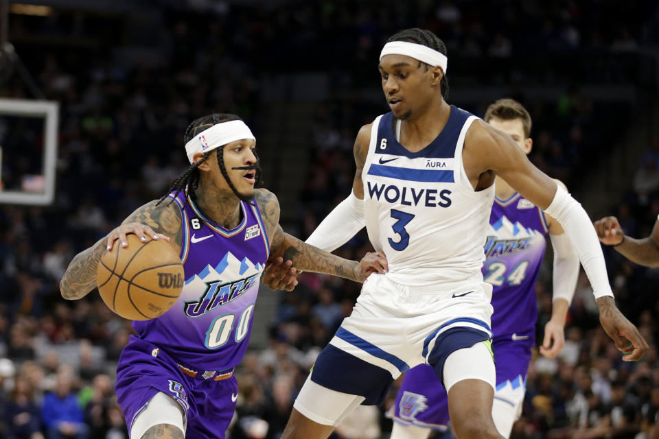 Utah Jazz guard Jordan Clarkson (00) drives against Minnesota Timberwolves forward Jaden McDaniels (3) in the second quarter of an NBA basketball game Monday, Jan. 16, 2023, in Minneapolis. (AP Photo/Andy Clayton-King)