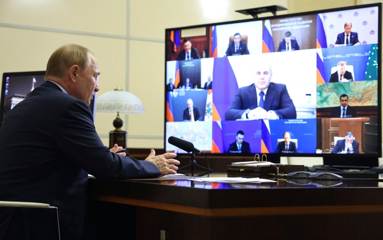 Vladimir Putin chairs a meeting with members of his government via videoconference at the Novo-Ogaryovo state residence, outside Moscow, today