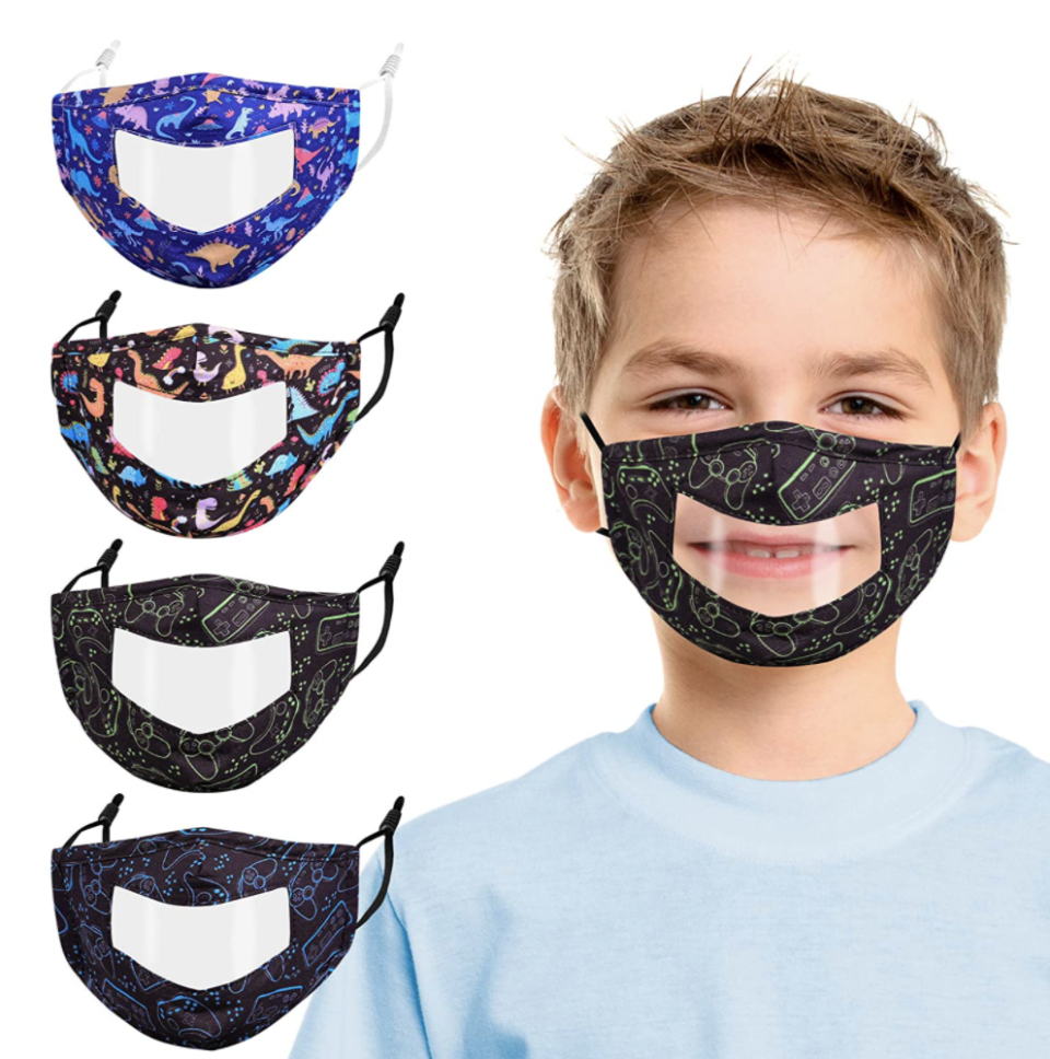 blonde little boy wearing a black transparent face mask and blue t-shirt