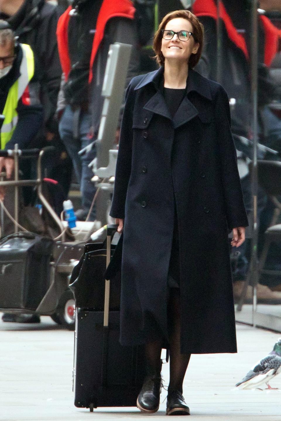 <p>Michelle Dockery has her eyes on the sky on Saturday while filming <em>Anatomy of a Scandal</em> in London.</p>