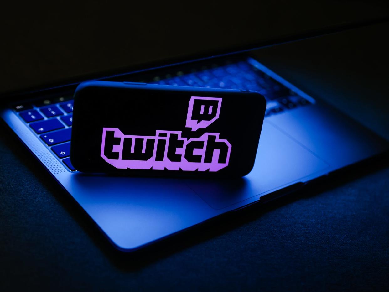 Twitch on phone screen atop a computer keyboard.