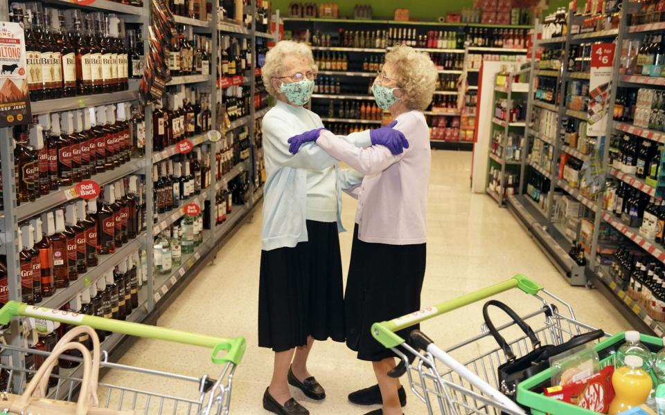 Twins Doris Hobday (L) and Lil Cox (R) pictured on a visit to Asda in August 2020 on what was their first trip out of the house for six months - Roland Leon/Daily Mirror 