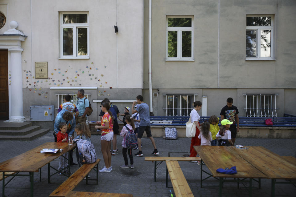 Ukrainian refugee children gather outside the Lauder Morasha Jewish school in Warsaw, Poland, Thursday, July 28, 2022. A special summer camp run by Jewish organizations has brought Jewish volunteers from the former Soviet Union to Warsaw to help Ukrainian children. The camp, which ran for most of July and ended Friday, was organized to bring some joy to traumatized children, help prepare them for the school year ahead in Polish schools and give their mothers some time to themselves. (AP Photo/Michal Dyjuk)