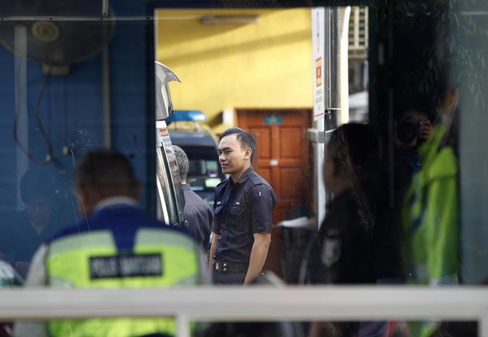Police officers stay inside the guard post of the forensic department at Kuala Lumpur Hospital in Kuala Lumpur, Malaysia, Saturday, Feb. 25, 2017. According to police Friday, forensics stated that the banned chemical weapon VX nerve agent was used to kill Kim Jong Nam, the North Korean ruler's outcast half brother who was poisoned last week at the airport. (AP Photo/Daniel Chan)
