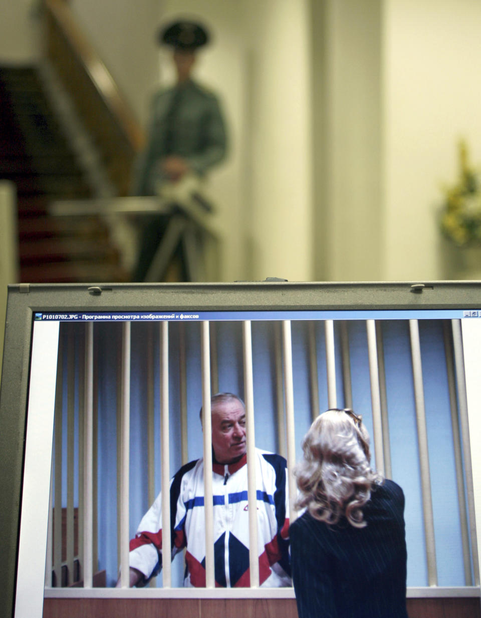 FILE - Sergei Skripal, left, is seen on a screen speaking to his lawyer from behind bars in Moscow on Aug. 9, 2006. Later released from prison in a spy swap, Skripal defected to Britain. He and his daughter, Yulia, were found slumped on a bench in Salisbury, England, in March 2018. British investigators said they had been poisoned with a Russian-developed nerve agent and blamed Moscow for the attack. Moscow denied the allegations. (AP Photo/Misha Japaridze)