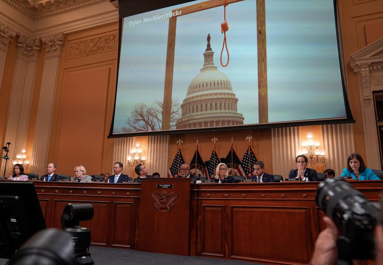 A video plays showing an image from Jan. 6, 2021 of a gallows in front of the U.S. Capitol on a large screen during the opening moments on June 16 of the House select committee to investigate the Jan. 6th attack on the Capitol.