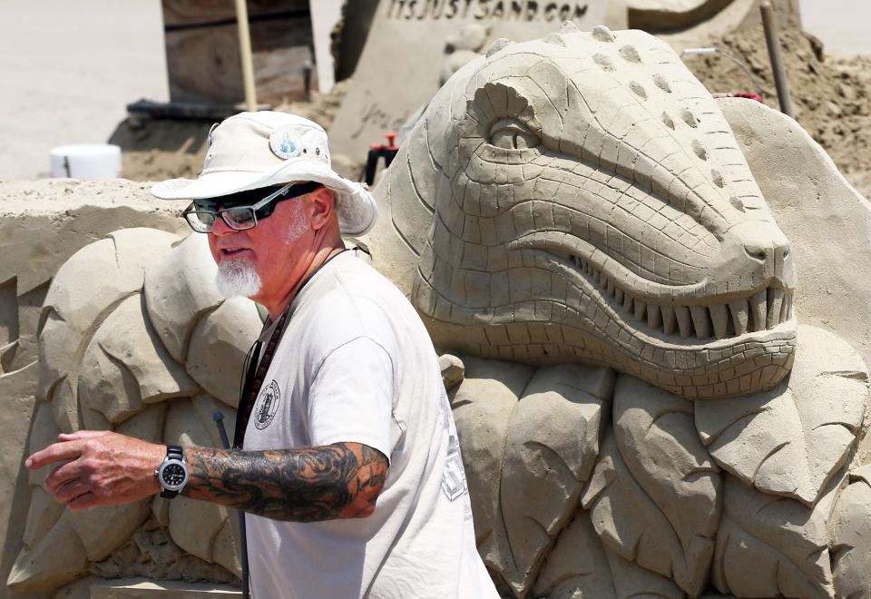 Sculptor Bruce Phillips from San Diego, Ca. gets ready to take a lunch break while creating the sponsor site for the 23rd Annual Hampton Beach Sand Sculpting Classic June 12, 2023.